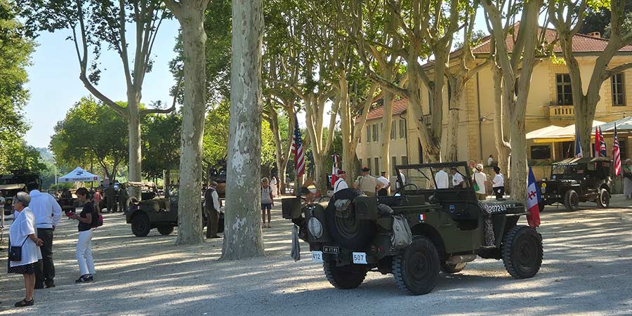 Military jeeps under the trees in Place de l’Horloge, Avignon